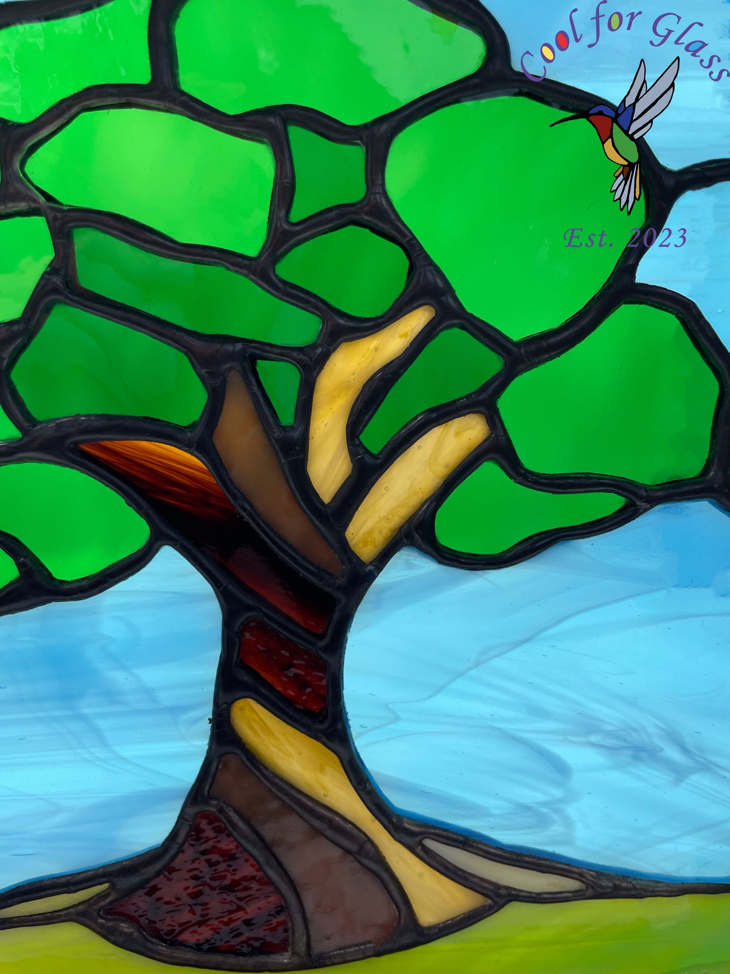 'Old Oak Tree' stained glass panel framed in sustainably sourced oak.