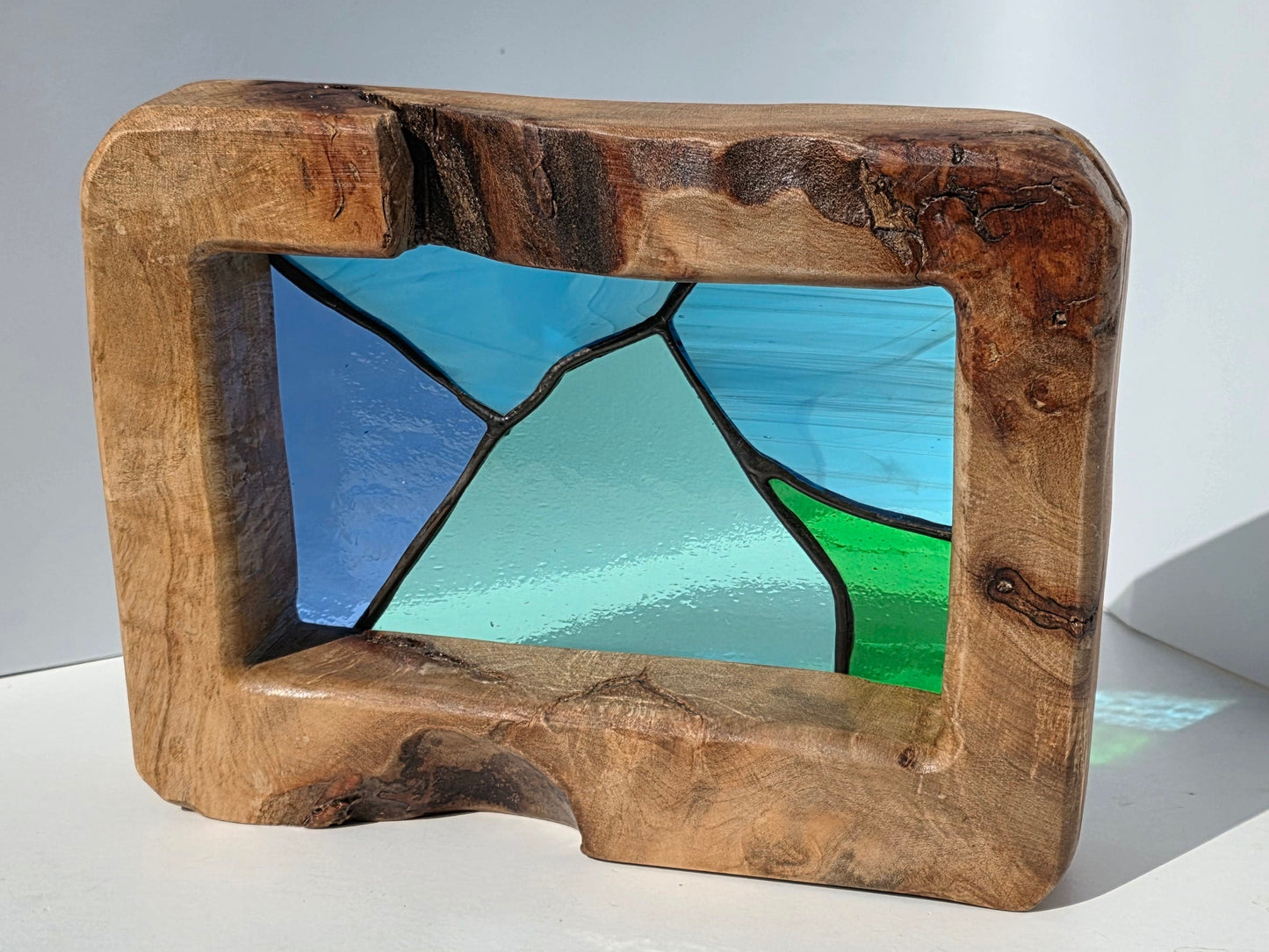 Abstract landscape stained glass in a solid oak frame