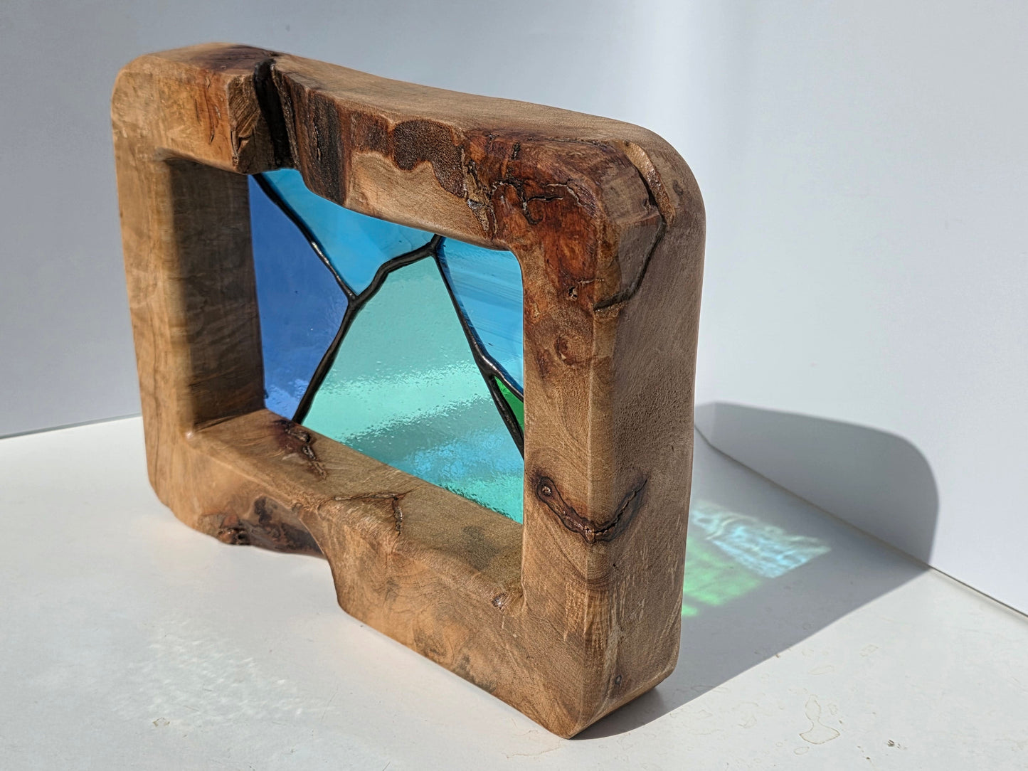Abstract landscape stained glass in a solid oak frame
