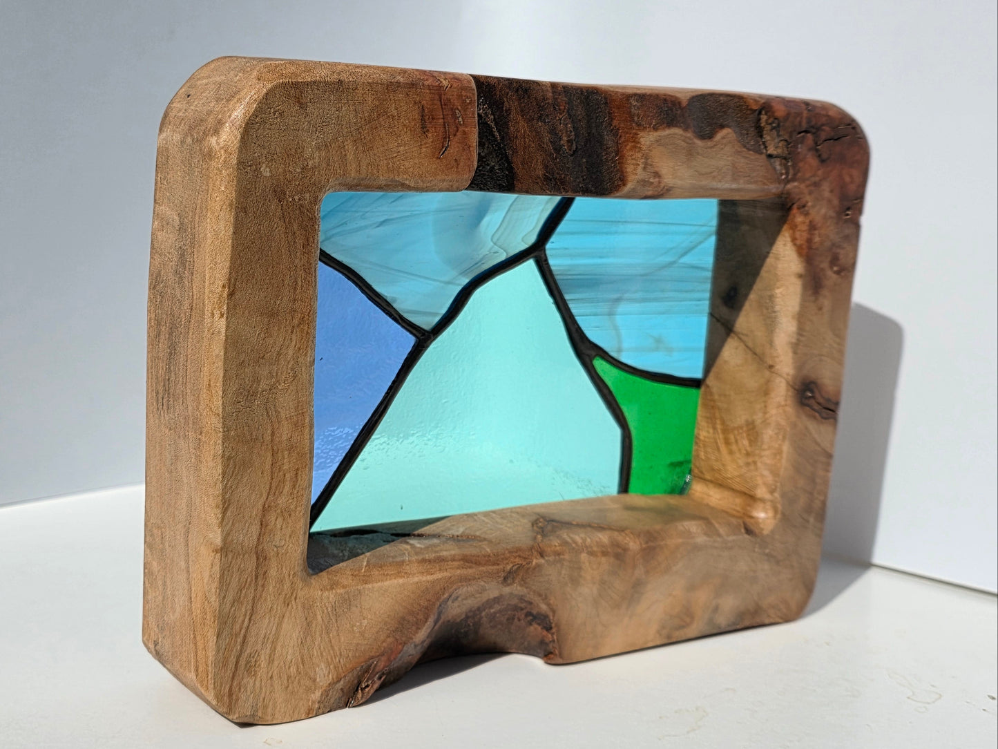 Abstract landscape stained glass in a solid oak frame