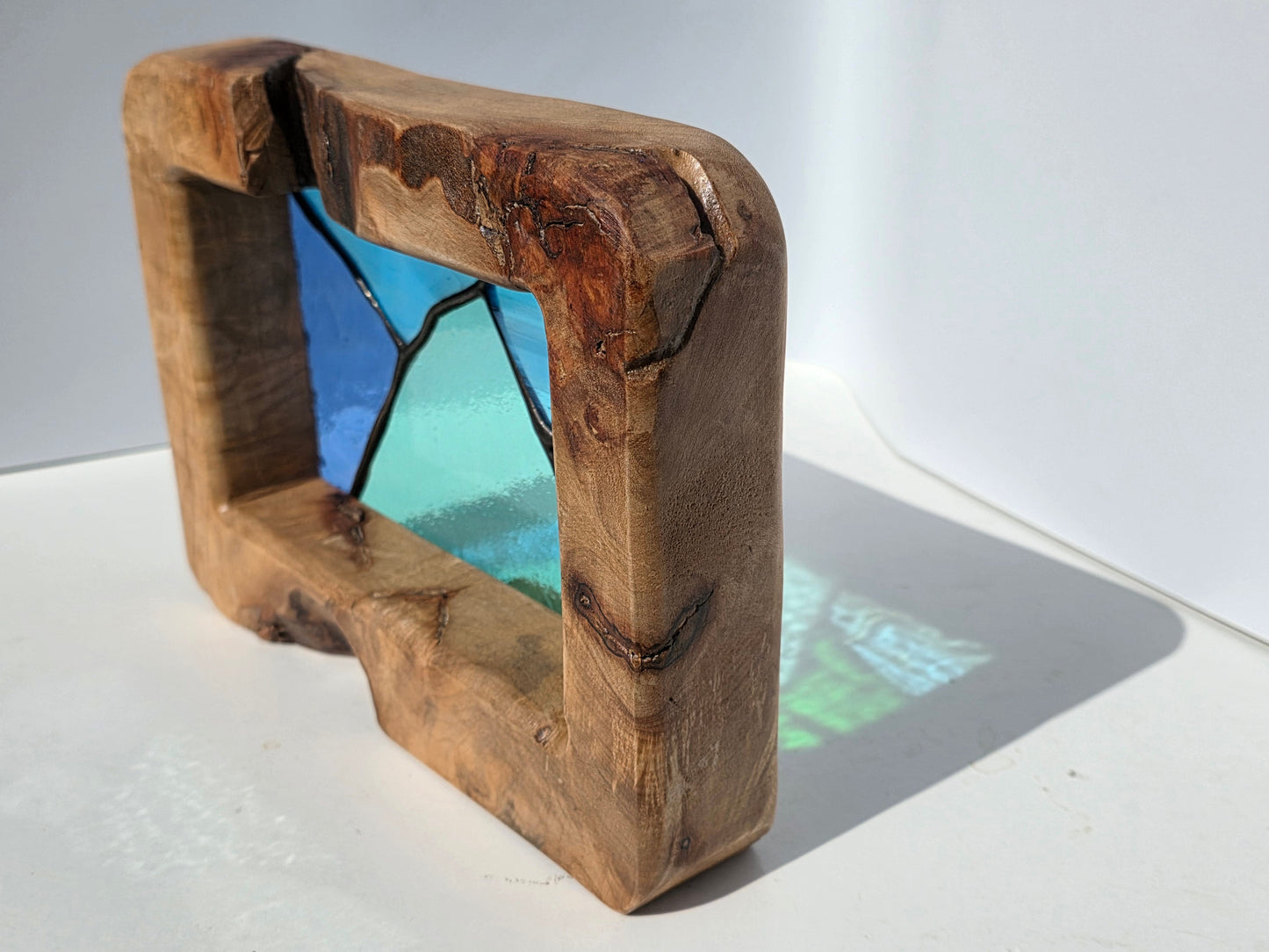 Abstract landscape stained glass in a solid oak frame