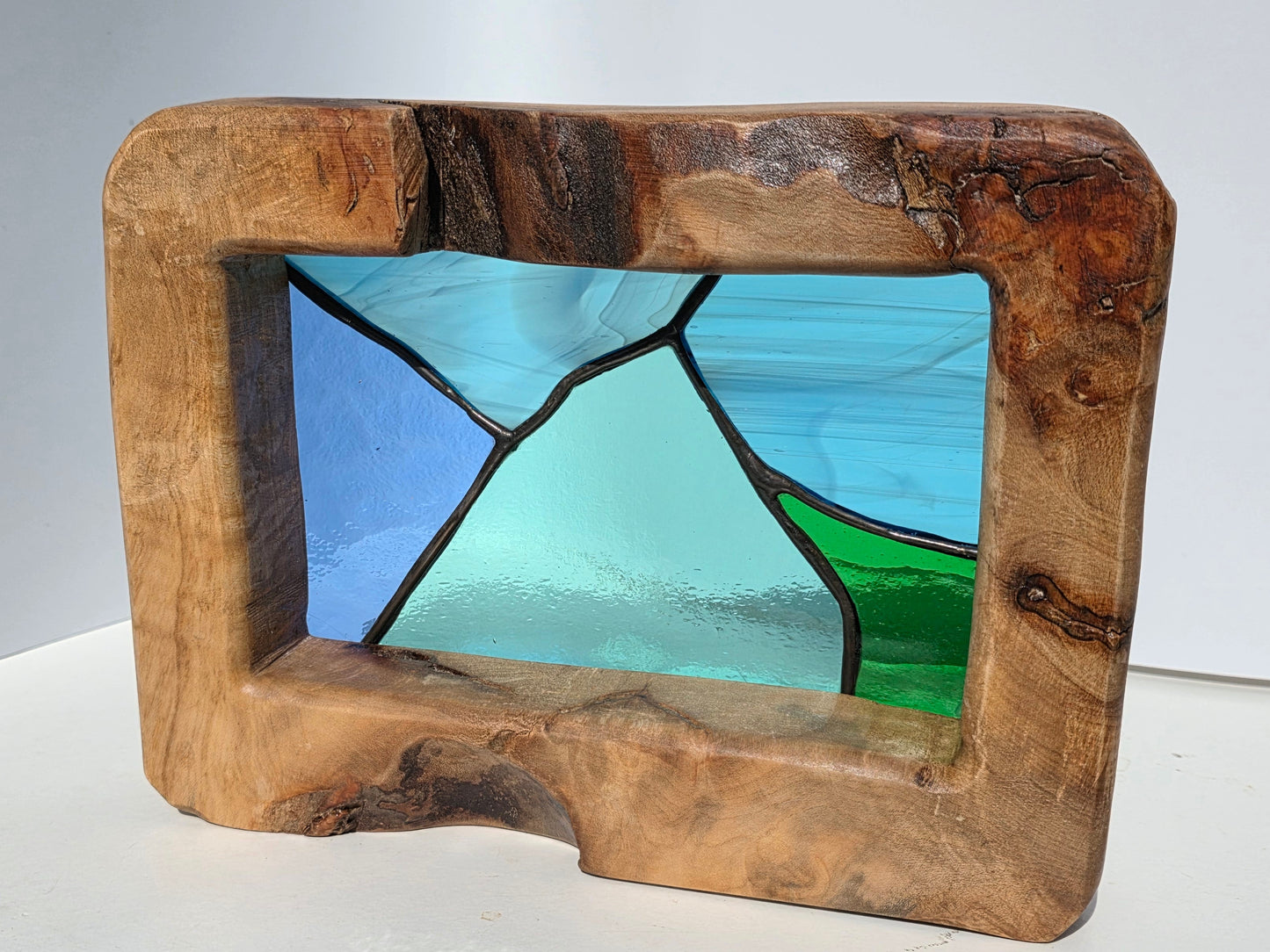 Abstract landscape stained glass in a solid oak frame