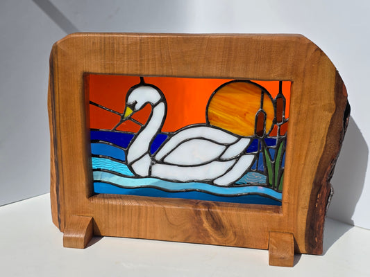 Stained glass 'Swan at Sunset' frames in a solid wood frame.
