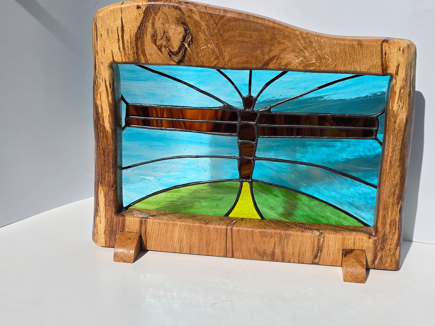 Stained glass 'Angel of the North' in a solid wood frame.