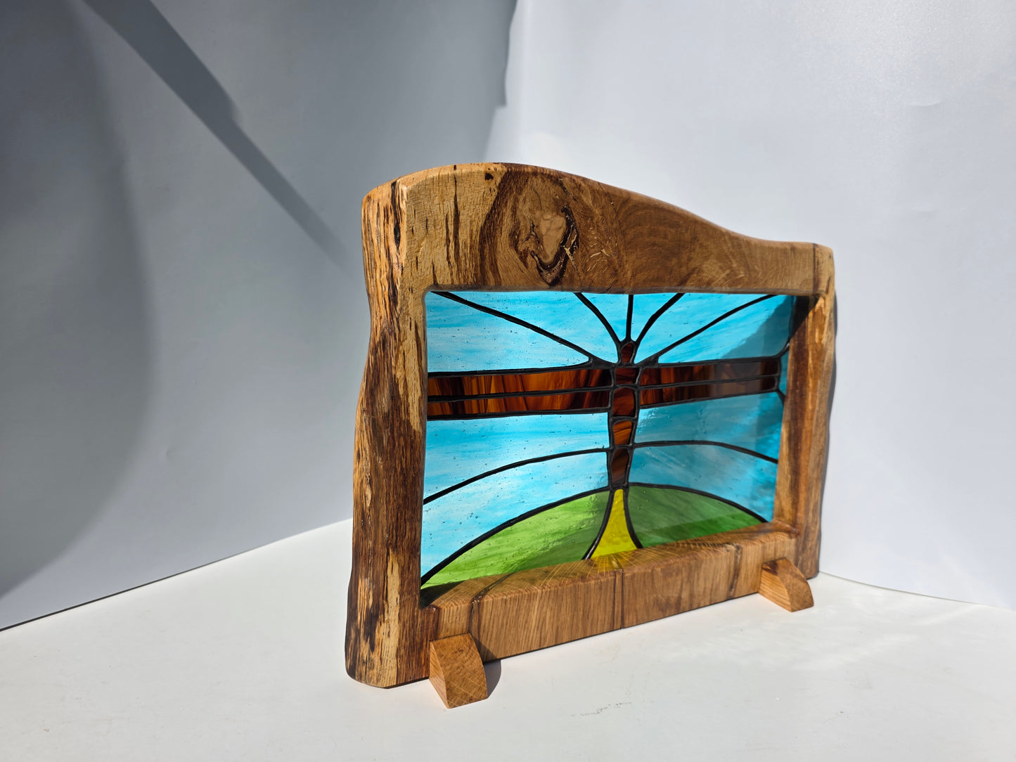 Stained glass 'Angel of the North' in a solid wood frame.